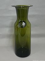 Full front view of olive green Holmegaard art glass vase