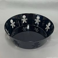 Top angle of black Alessi bowl showing cut-out figures