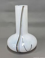 Side view of white Kosta Boda Rainbow vase showing multicoloured stripe