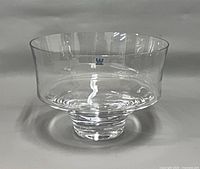 Front view of clear art glass footed bowl showing brand sticker and profile