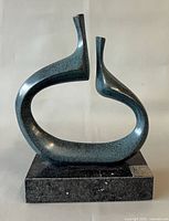 Front view of abstract metal sculpture on stone base