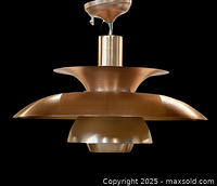 Full view of copper pendant light against black background