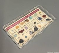 Closed display case showing gemstone grid and title card