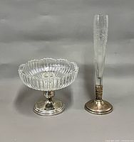 Overall view of cut-glass bowl and etched vase with sterling bases