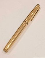 Full view of closed gold-plated Waterman fountain pen