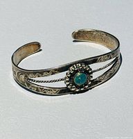 Top view showing turquoise cabochon, twisted wire and stamped designs