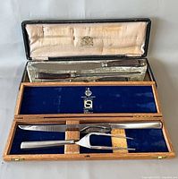 Both carving sets displayed in their open cases