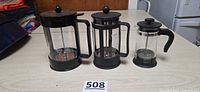 Group shot of three French presses in varying sizes