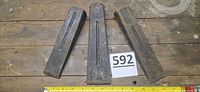 All three steel wedges laid out on wood surface with lot tag and ruler.
