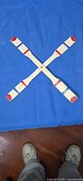 Full view of cross boomerang on blue cloth