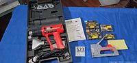 Overall lot showing heat gun in case, staple gun, four staple packs, instruction sheet