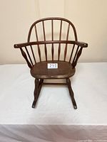 Front view of wooden child’s Windsor rocking chair
