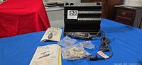 Full lot view: rotary tool, manuals, organizer, sealed accessory bags
