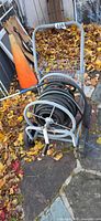 Full view of steel hose reel cart with hose wound on reel