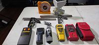 Full lot showing stud finders, laser levels, combination squares, angle locator and multi-angle level
