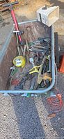 Overview of cart full of assorted garden hand tools and accessories