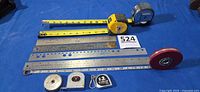 All measuring tools laid out on blue surface showing quantity and variety