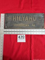 Front of metal sign with rulers showing 15" width and 6" height