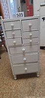 Front view of white nine-drawer chest
