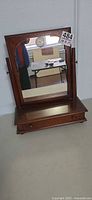 Front view of mahogany tabletop mirror with drawer