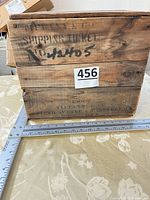 Side of crate showing stenciled text and dimensions reference