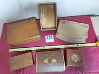 Six assorted boxes arranged with measuring tape for scale