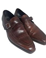 Three-quarter view of both shoes showing uppers, buckle, stitching