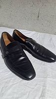 Side view of both loafers showing overall condition, leather quality, and toe shape