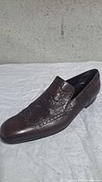 Side view of right loafer showing embossed pattern and leather condition