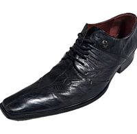 single shoe side profile showing leather texture and long pointed toe