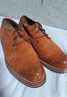 Oblique view of both shoes showing uppers, laces and toe condition