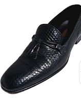Single shoe angled view showing woven leather pattern and tassel detail