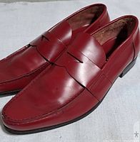 Left side view of both red leather loafers