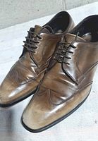 Oblique view of both shoes showing uppers, lacing and toe condition