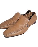 Side view of both loafers showing leather condition and buckle detail