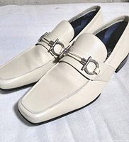 pair of off-white leather Ferragamo loafers angled view showing uppers and hardware
