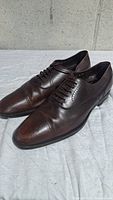 Angled front view of brown leather Oxford shoes