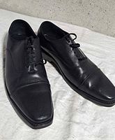 pair black leather shoes angled view