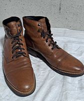 three-quarter view of both boots showing uppers and toe condition