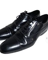 Three-quarter view of both shoes showing upper, laces, and toe condition