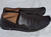 Left side profile of both loafers showing leather quality and stitching