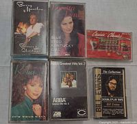First group of six cassettes laid out front covers visible