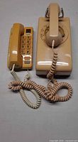 Both telephones side by side showing overall condition and cords