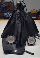 Camera cover displayed upright with two LED lights attached