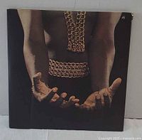 Gatefold inner image featuring Isaac Hayes' torso with chains and open hands