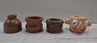 Front view of all four miniature vessels