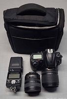 Group shot of camera, two lenses, flash, and case