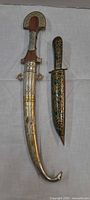 Both daggers with sheaths side by side