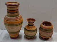 Front view of three vases showing height differences and decorative pattern