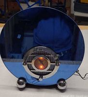 Front view of Thomas TPC-109 radio showing blue mirrored face, chrome dial, knobs, feet